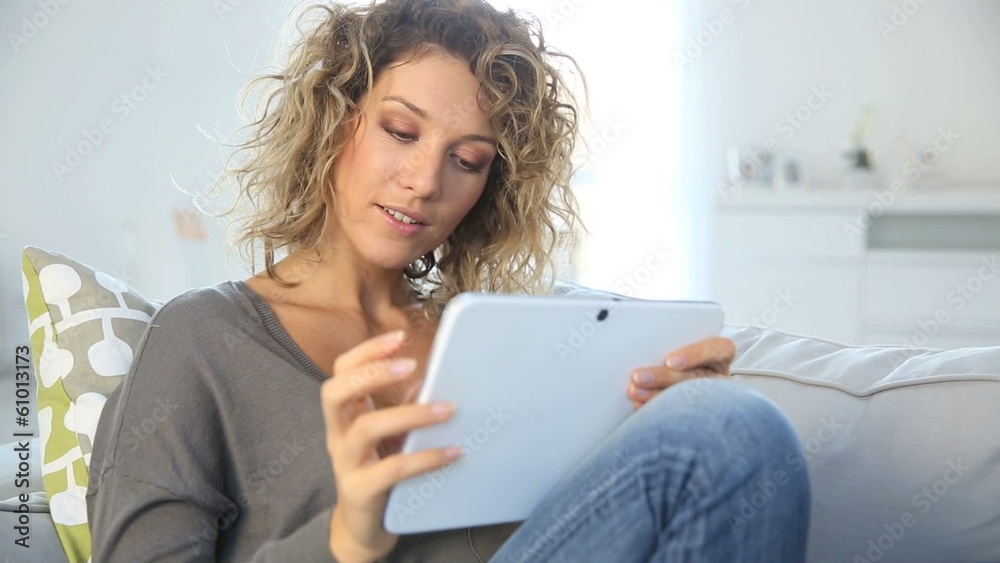 Smiling gorgeous woman websurfing on tablet Smiling gorgeous woman websurfing on tablet