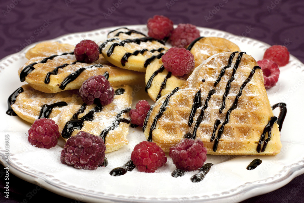 Heart shaped waffles with raspberries Heart shaped waffles with raspberries