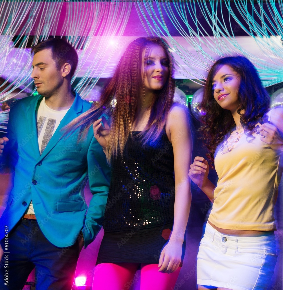 Group of happy young people dancing at night club Group of happy young people dancing at night club