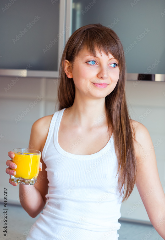 Young caucasian brunette girl with a glass of juice