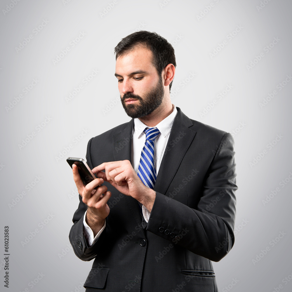 Business man sending a message over grey background. Business man sending a message over grey background.