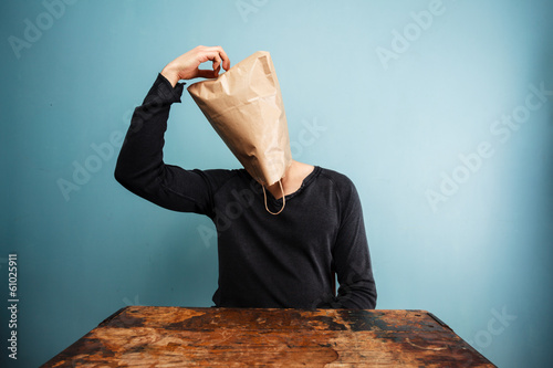 confused man with bag over head photo