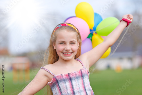 girl with balloons running