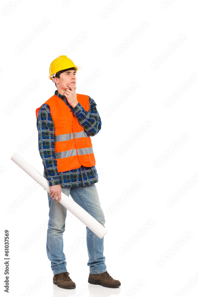 Smiling construction worker holding rolled paper plan. Smiling construction worker holding rolled paper plan.