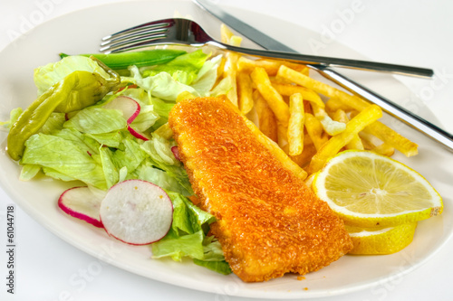 Fish and chips portion on plate with fork and knife