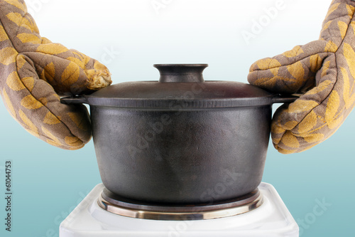 Oven mitts and hot cooking cauldron