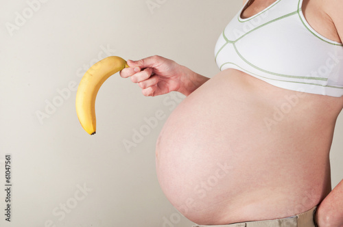 Obraz na plátně Pregnant woman with a droopy banana