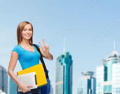 female student with bag  tablet pc and folders