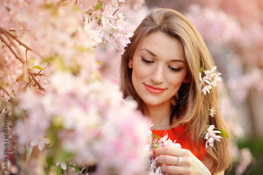 Portrait of beautiful woman near a flowering tree Portrait of beautiful woman near a flowering tree