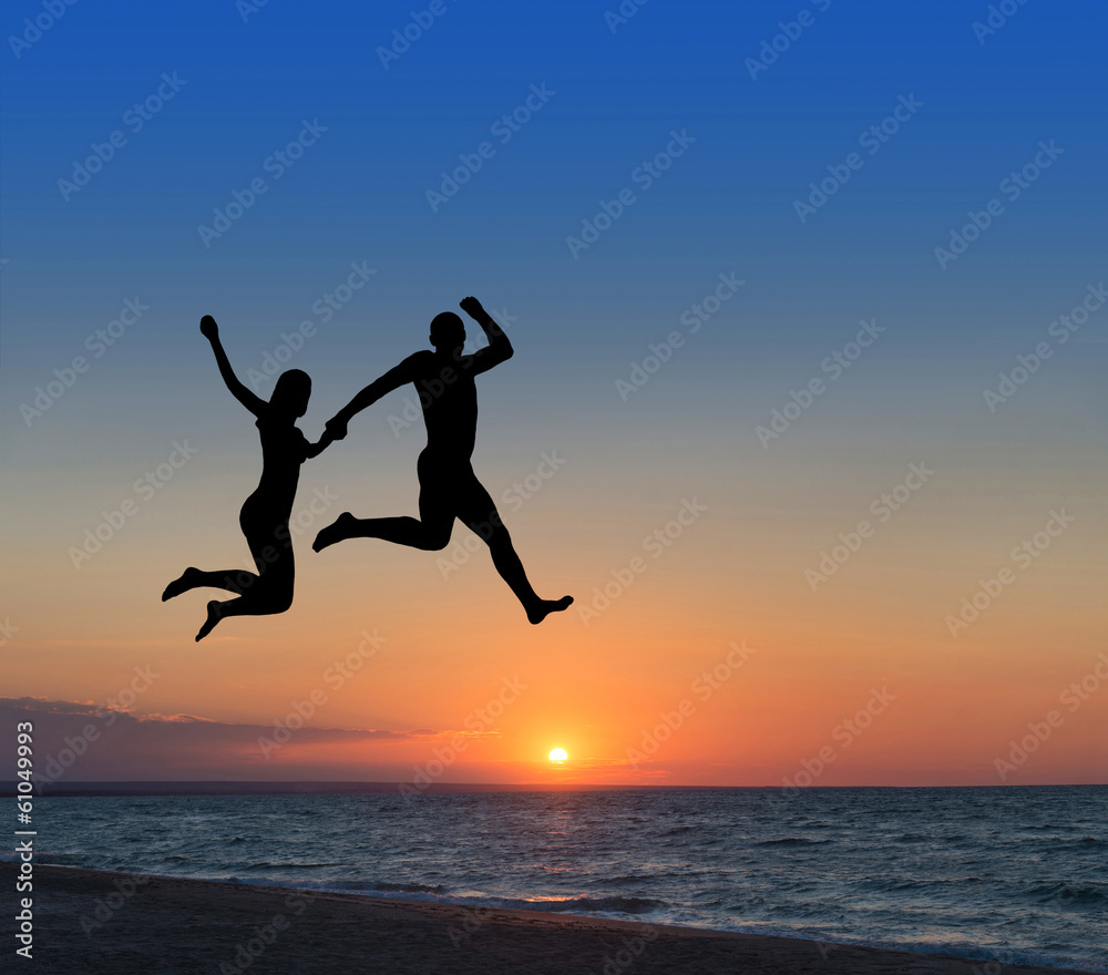 loving couple jumping highly in the sky at beach resort loving couple jumping highly in the sky at beach resort