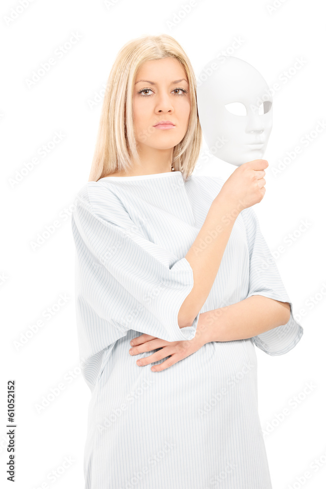 Blond female in hospital gown holding a theater mask Blond female in hospital gown holding a theater mask