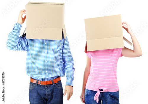 Couple with cardboard boxes on their heads isolated on white