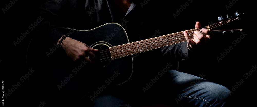 Young musician playing acoustic guitar and singing, - obrazy, fototapety, plakaty 