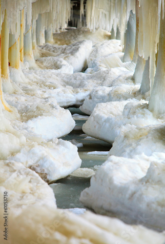 Winter. Baltic Sea. Ice formations icicles on pier poles