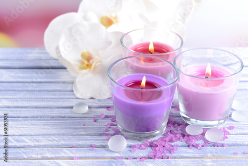Beautiful colorful candles and  orchid flowers 