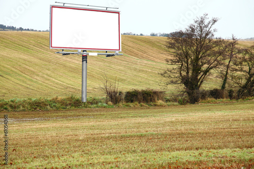 Blank white billboard in field