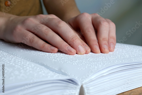 Blind woman read book written in Braille