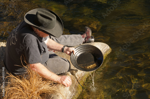 Foto Man beside river gold panning