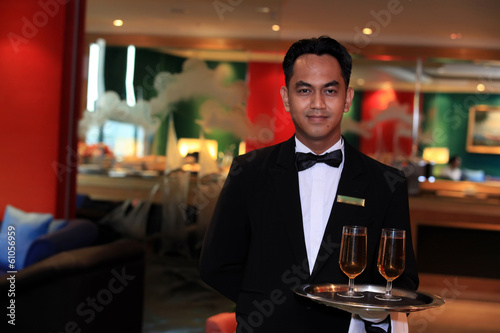 waiter or butler in uniform at five star hotel lounge