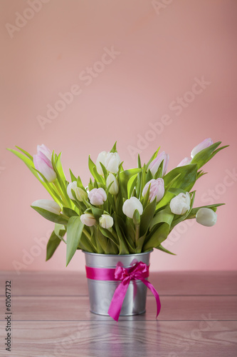 Rustic pot with white fresh tulips