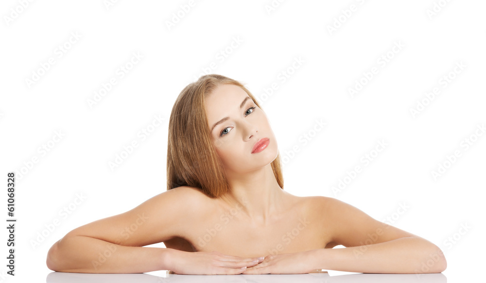 Obraz premium Beautiful caucasian naked woman lying on a table.