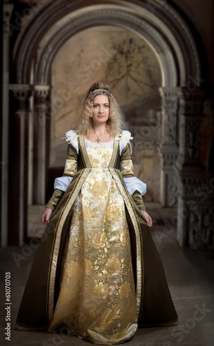 Woman in medieval dress, antique interior background