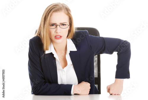 Attractive business woman by the table, bossy behaviour.