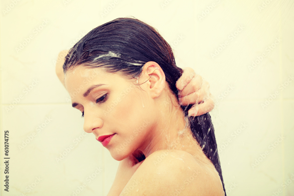 Beautiful young woman washing her hairs
