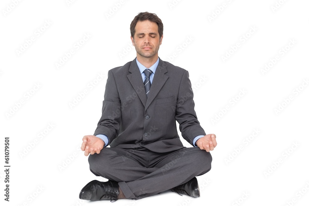 Calm businessman meditating in lotus pose Calm businessman meditating in lotus pose