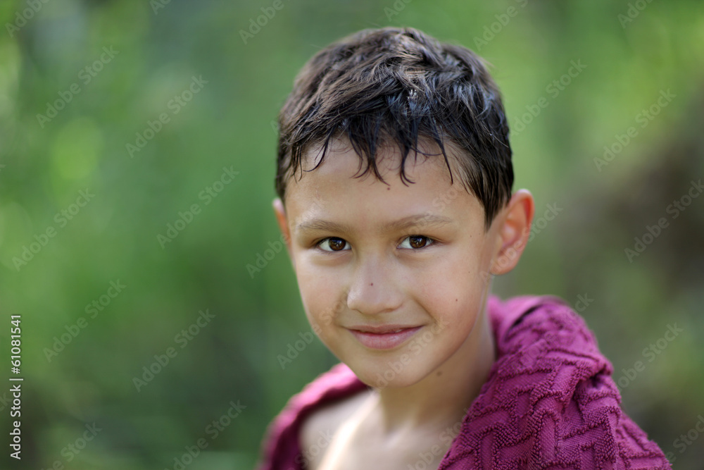little boy 10 years old against green grass colors little boy 10 years old against green grass colors