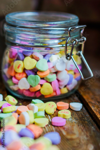 Heart candies on rustic wooden background