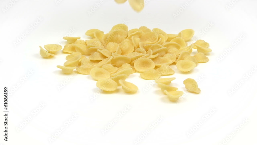 orecchiette pasta falling on white background in slow motion orecchiette pasta falling on white background in slow motion
