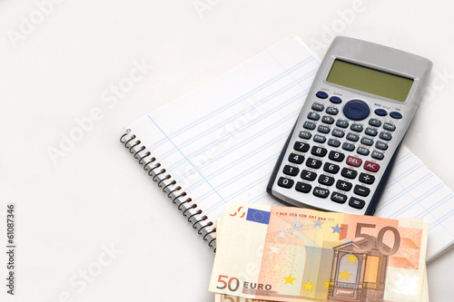 Calculator, bills and notepad photo