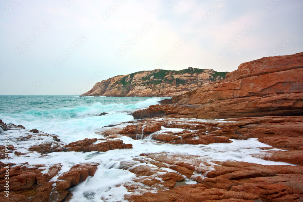 rocky sea coast and blurred water in shek o,hong kong