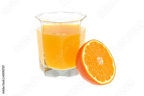 A half of orange with a glass filled with citrus juice isolated