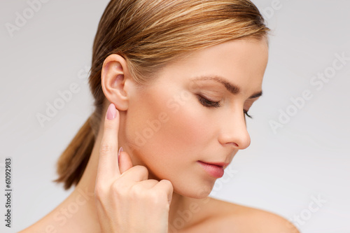 calm woman touching her ear photo