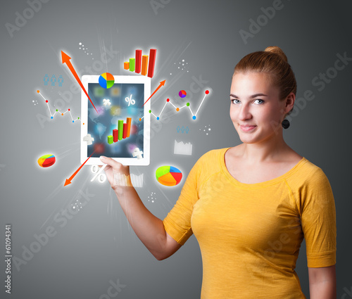 woman holding modern tablet with colorful diagrams and graphs photo