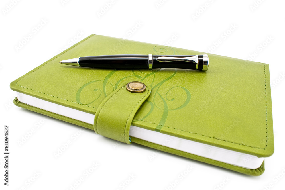 Pen and green notebook isolated on white Pen and green notebook isolated on white