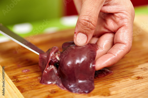 Slicing chicken liver photo