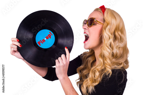 Isolated Pin-up girl touching vinyl LP with tongue