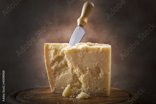 Parmesan cheese cutting on the chopping board photo