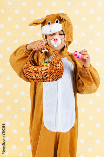 Child as easter hare with eggs photo