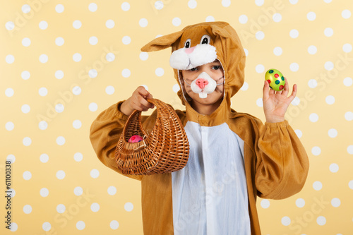 Child as easter hare with eggs photo