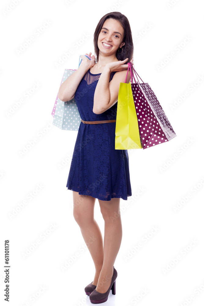 Lovely woman standing with shopping bags, isolated on white