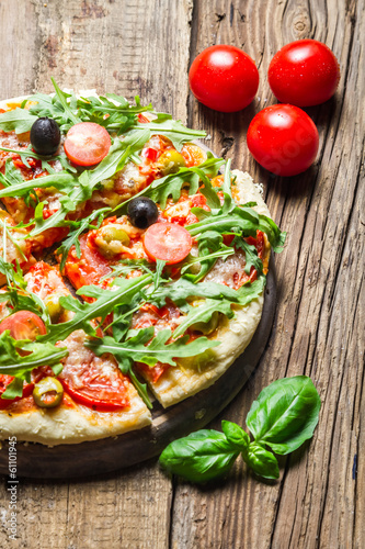 Freshly baked pizza with basil and tomatoes