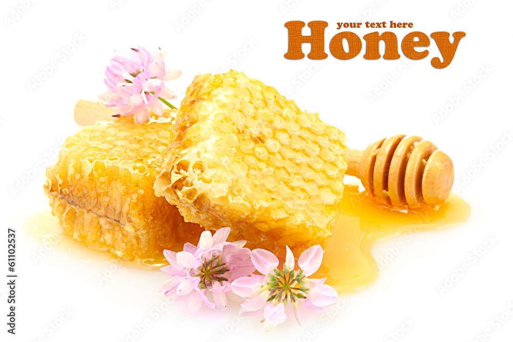 Golden honeycombs, wildflowers and wooden drizzler with honey Golden honeycombs, wildflowers and wooden drizzler with honey