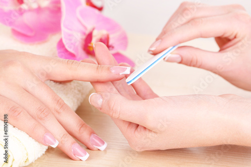 Manicure process in beauty salon close up