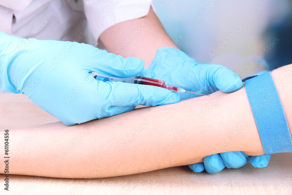 Nurse taking a blood sample, close up Nurse taking a blood sample, close up