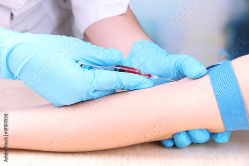 Nurse taking a blood sample, close up