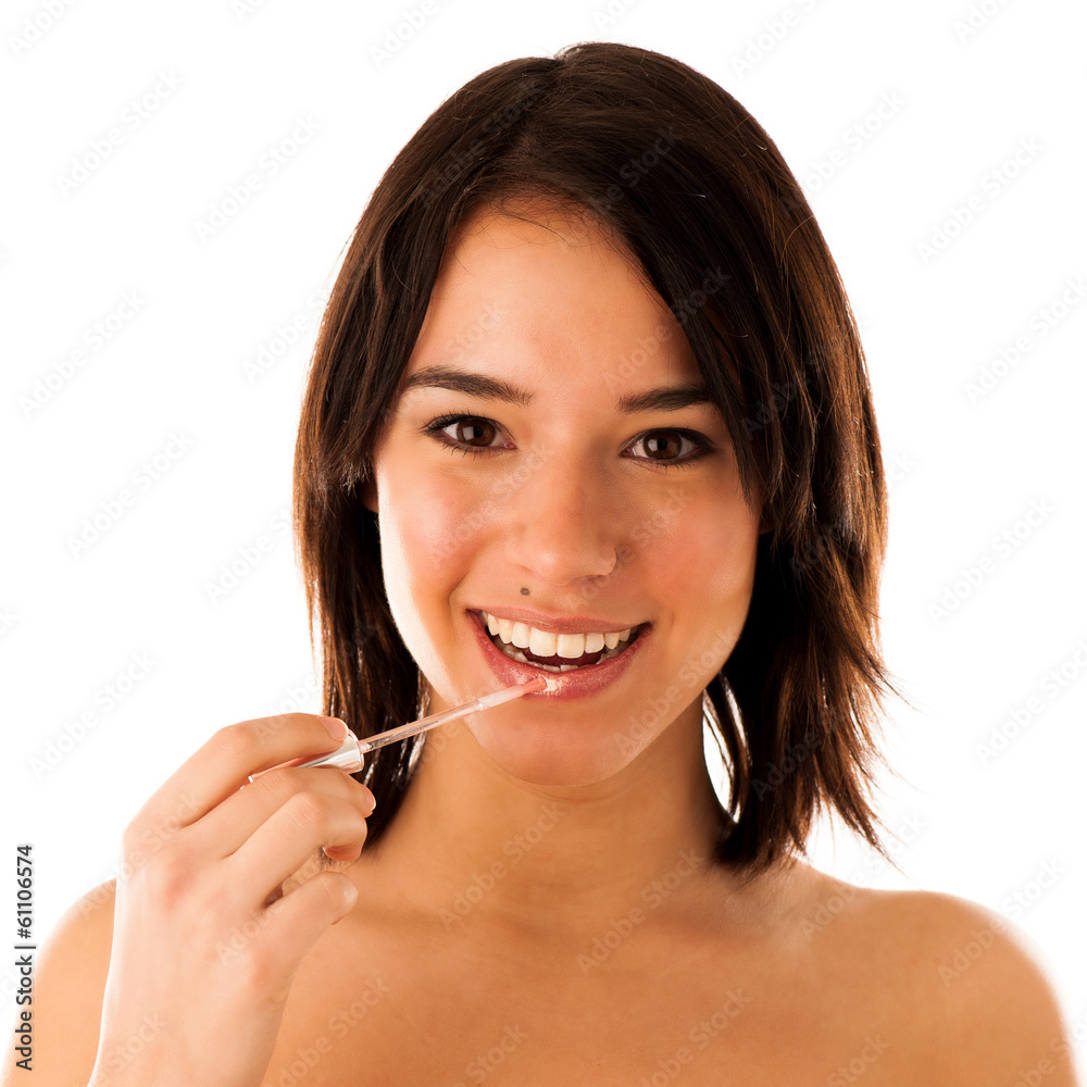 Beautiful young asian caucasian girl applying lipgloss on her l Beautiful young asian caucasian girl applying lipgloss on her l